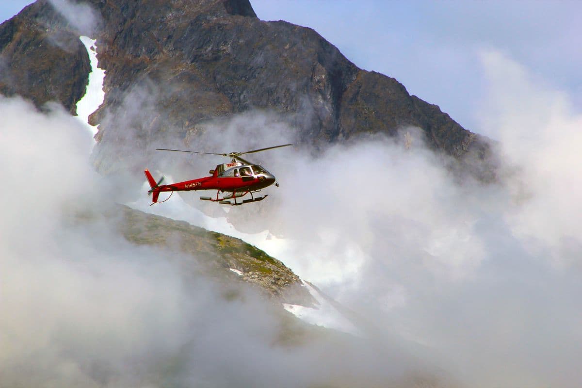 Helicóptero volando entre montañas