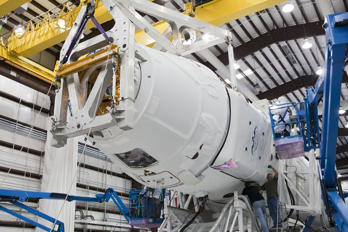Técnicos inspeccionando un componente aeroespacial de precisión en una fábrica